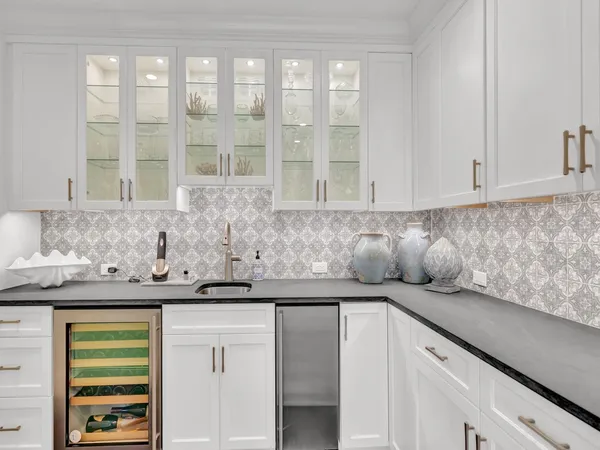 a kitchen with stainless steel appliances granite countertop a sink and a white cabinets