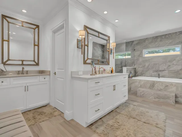 a bathroom with a double vanity sink mirror and double