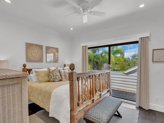 a bedroom with furniture and a large window