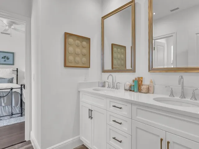 a bathroom with double sink and a mirror