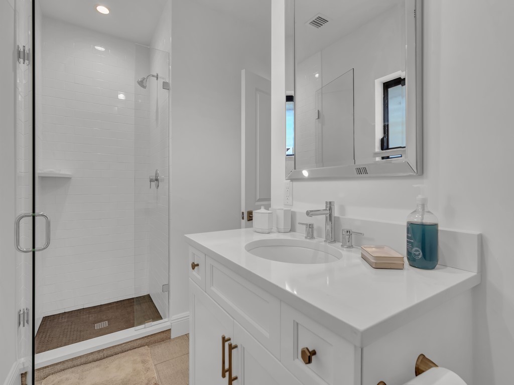 245 Springline Drive Vero Beach, FL 32963 - Photo 25 of 35 a bathroom with a sink and a mirror