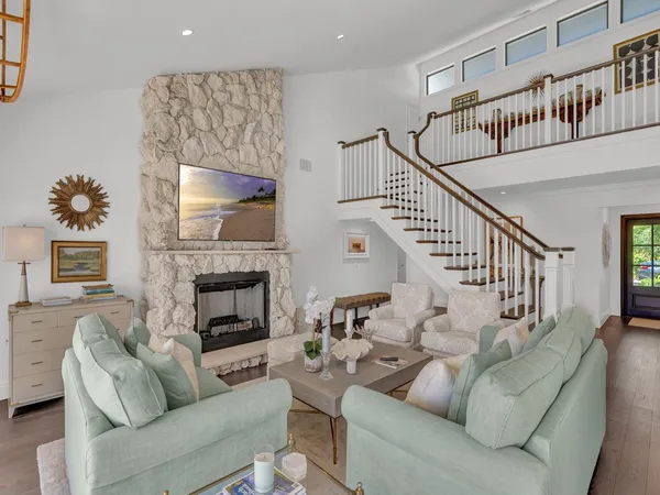 a living room with furniture and a fireplace