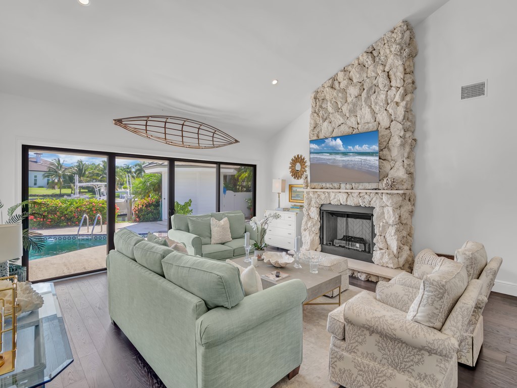 245 Springline Drive Vero Beach, FL 32963 - Photo 7 of 35 a living room with furniture and a fireplace