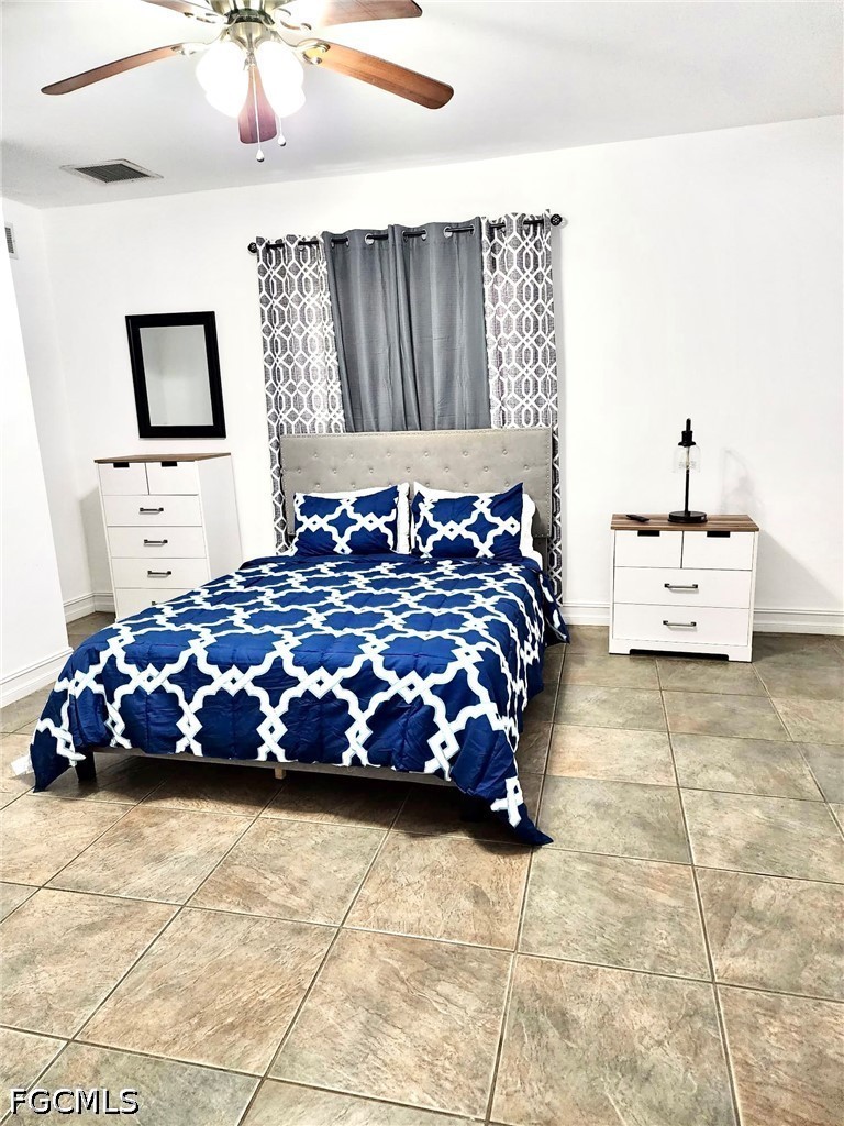 740 19th Street Southwest Naples, FL 34117 - Photo 31 of 35 a bedroom with a bed and painting on the wall
