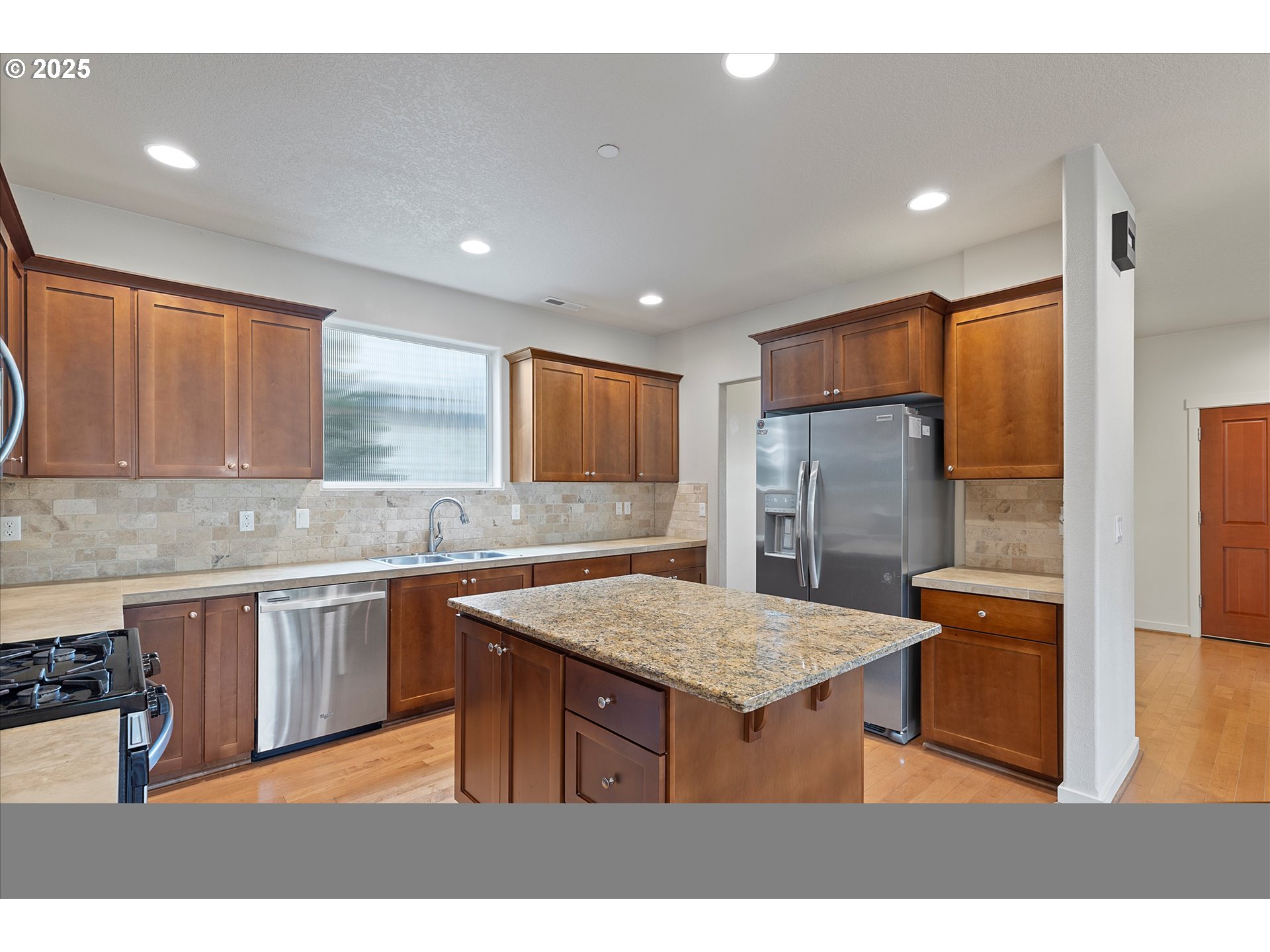 12001 Southwest Surrey Street Wilsonville, OR 97070 - Photo 12 of 48 a kitchen with a sink refrigerator and microwave