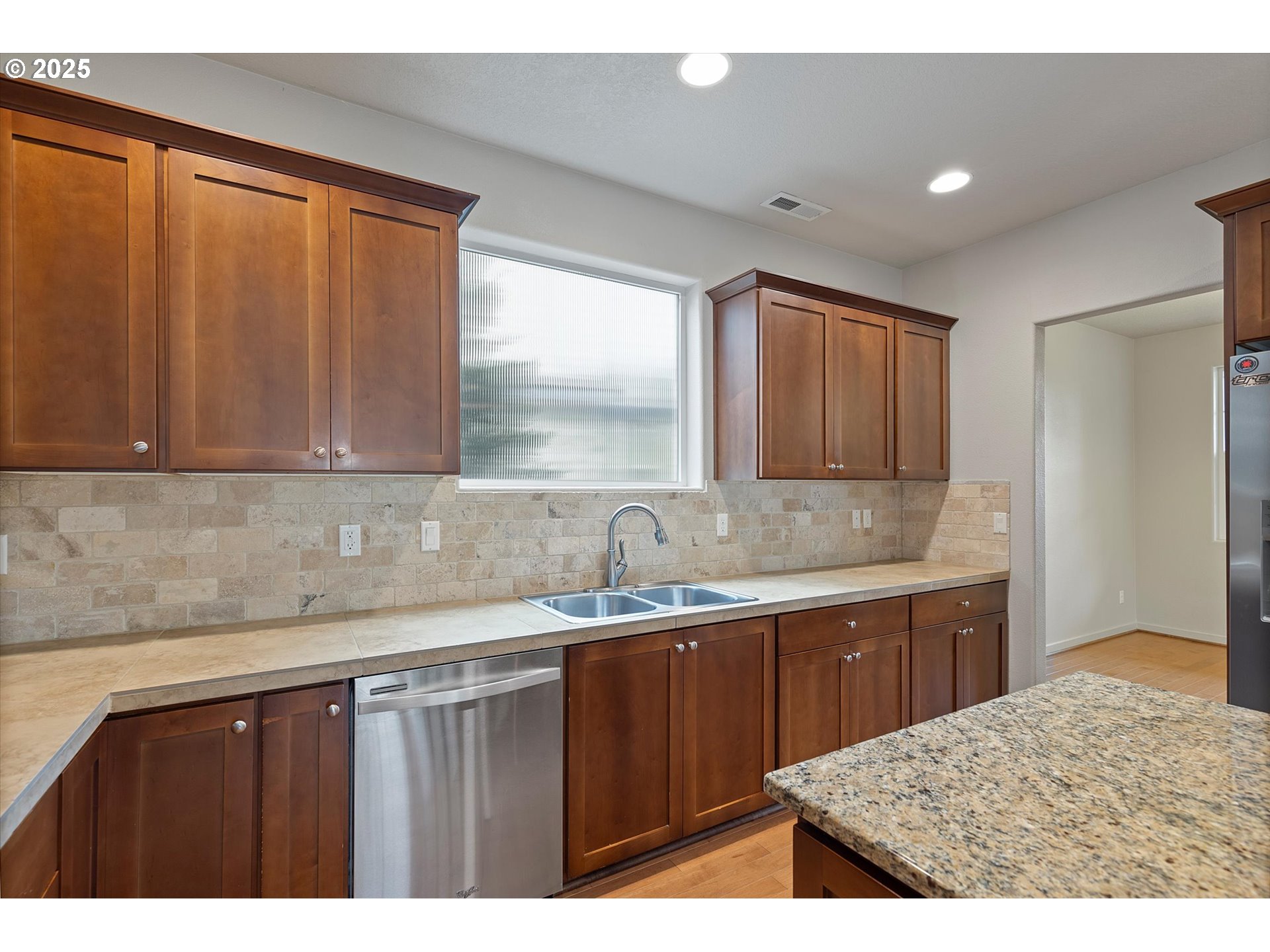 12001 Southwest Surrey Street Wilsonville, OR 97070 - Photo 13 of 48 a kitchen with a sink and cabinets