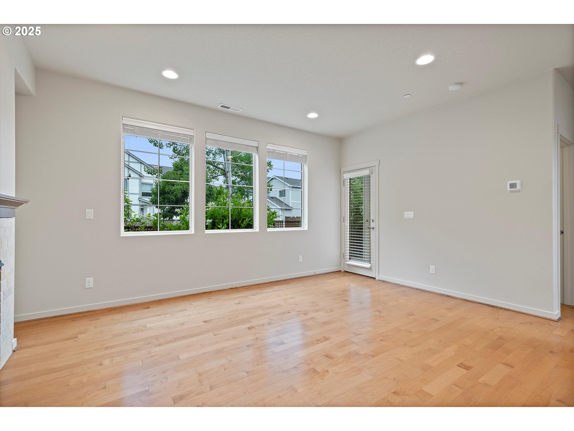 12001 Southwest Surrey Street Wilsonville, OR 97070 - Photo 15 of 48 a view of an empty room with wooden floor and windows