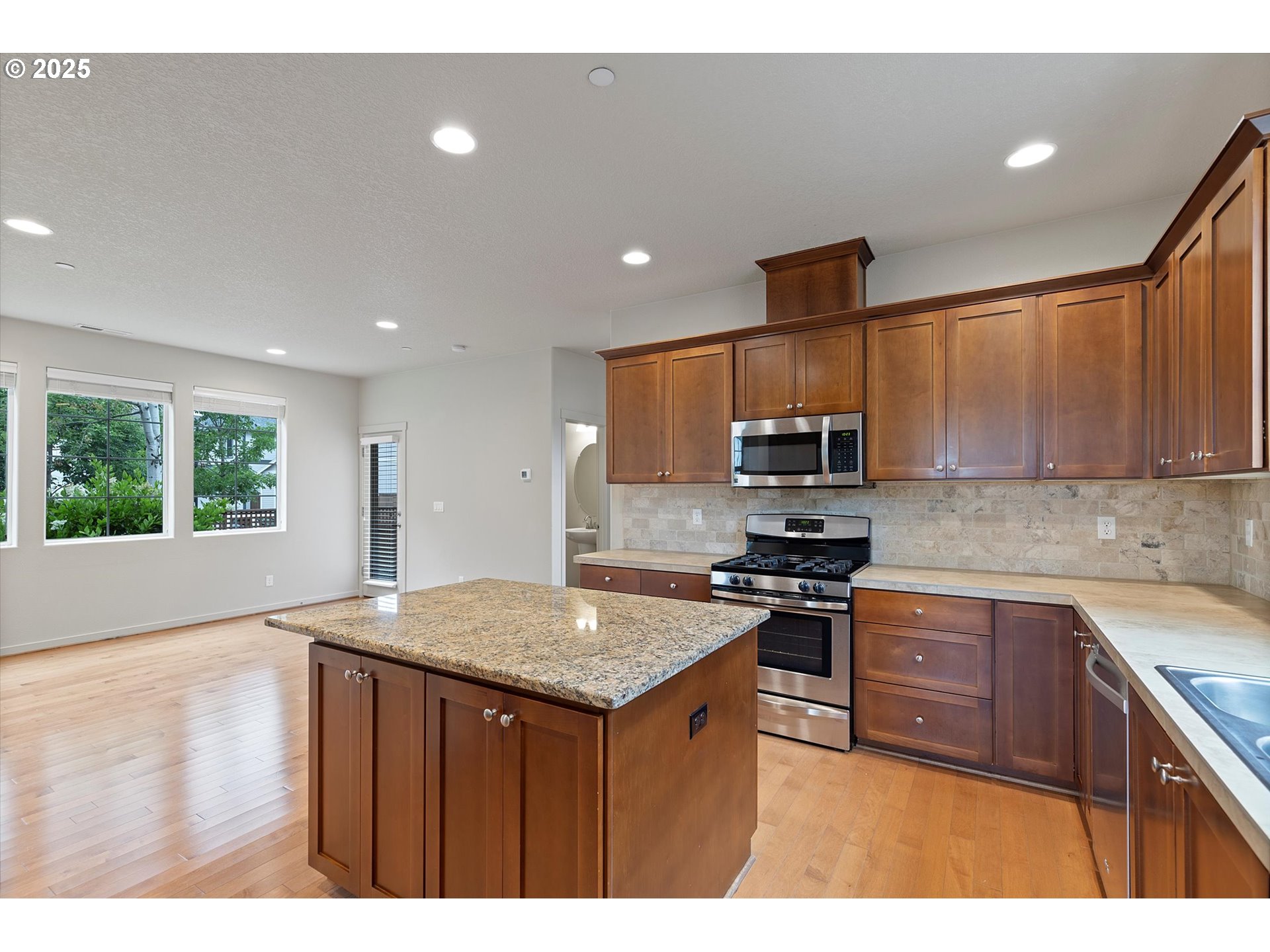 12001 Southwest Surrey Street Wilsonville, OR 97070 - Photo 17 of 48 a kitchen with a sink stove and refrigerator