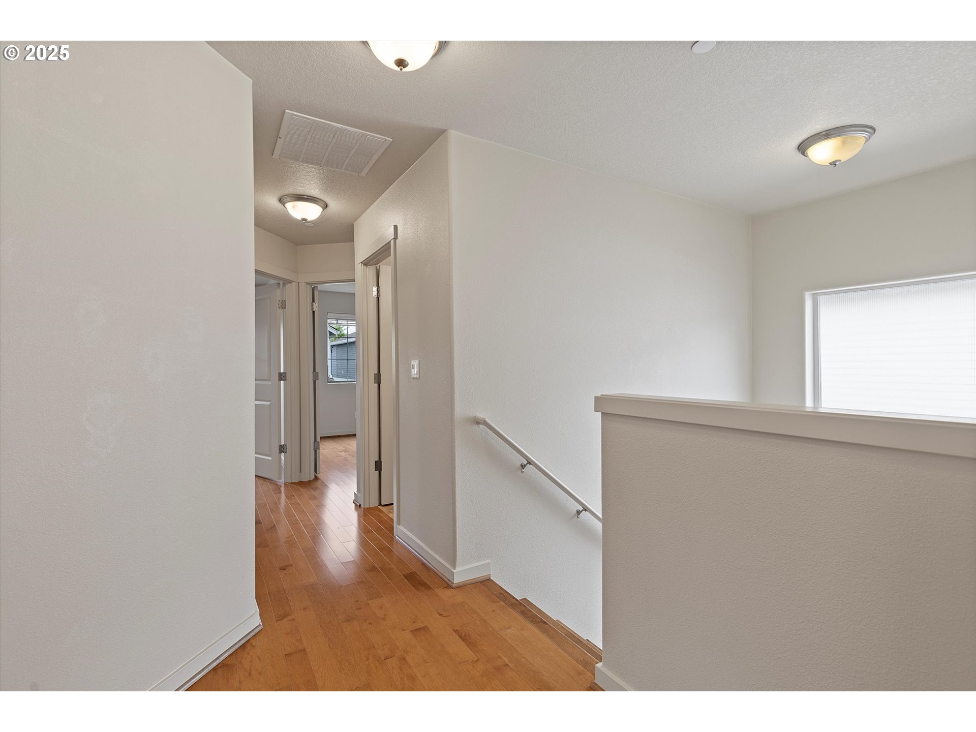 12001 Southwest Surrey Street Wilsonville, OR 97070 - Photo 19 of 48 a view of an empty room with wooden floor and a window