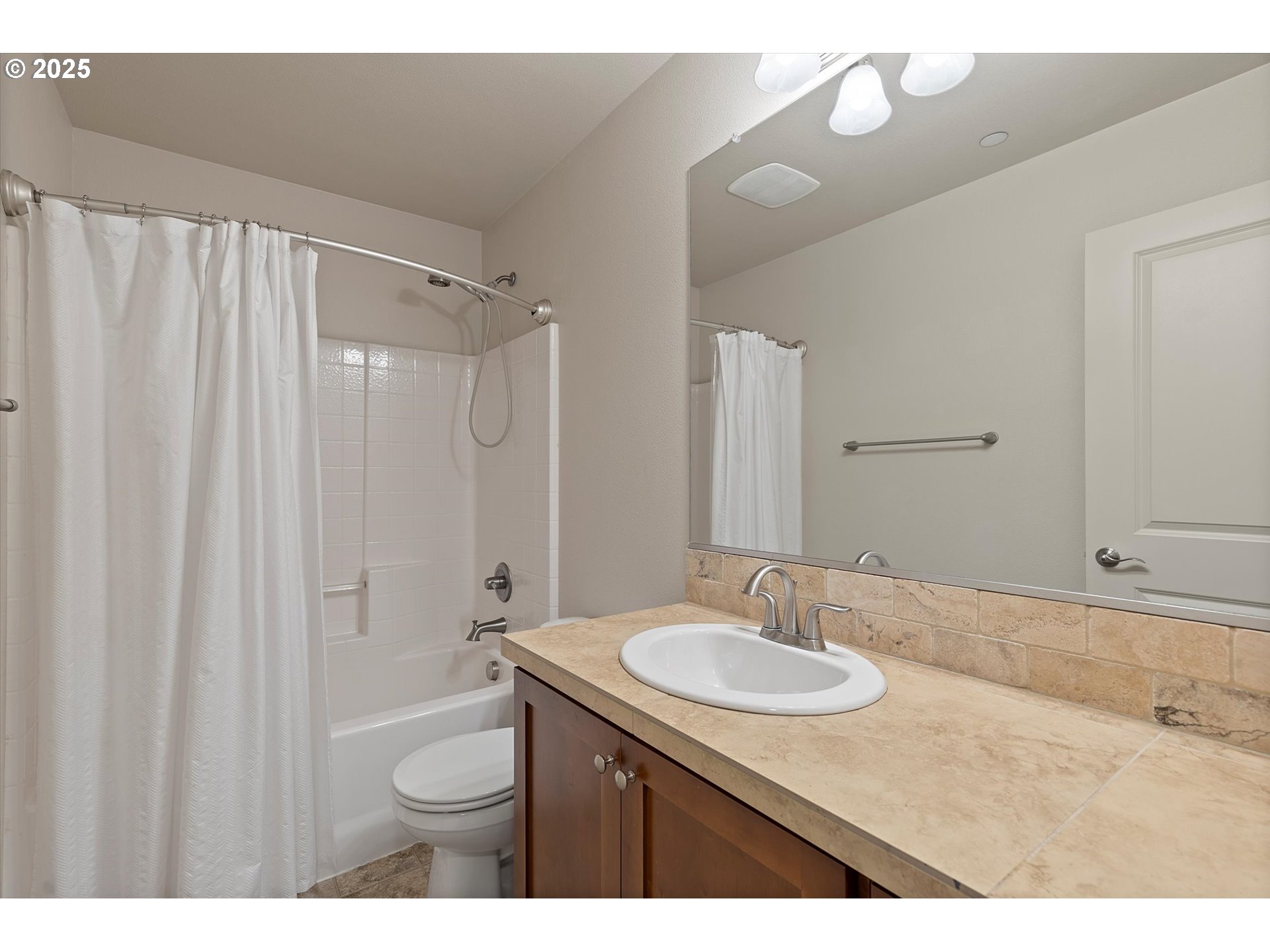 12001 Southwest Surrey Street Wilsonville, OR 97070 - Photo 20 of 48 a bath room with a sink vanity granite and a mirror