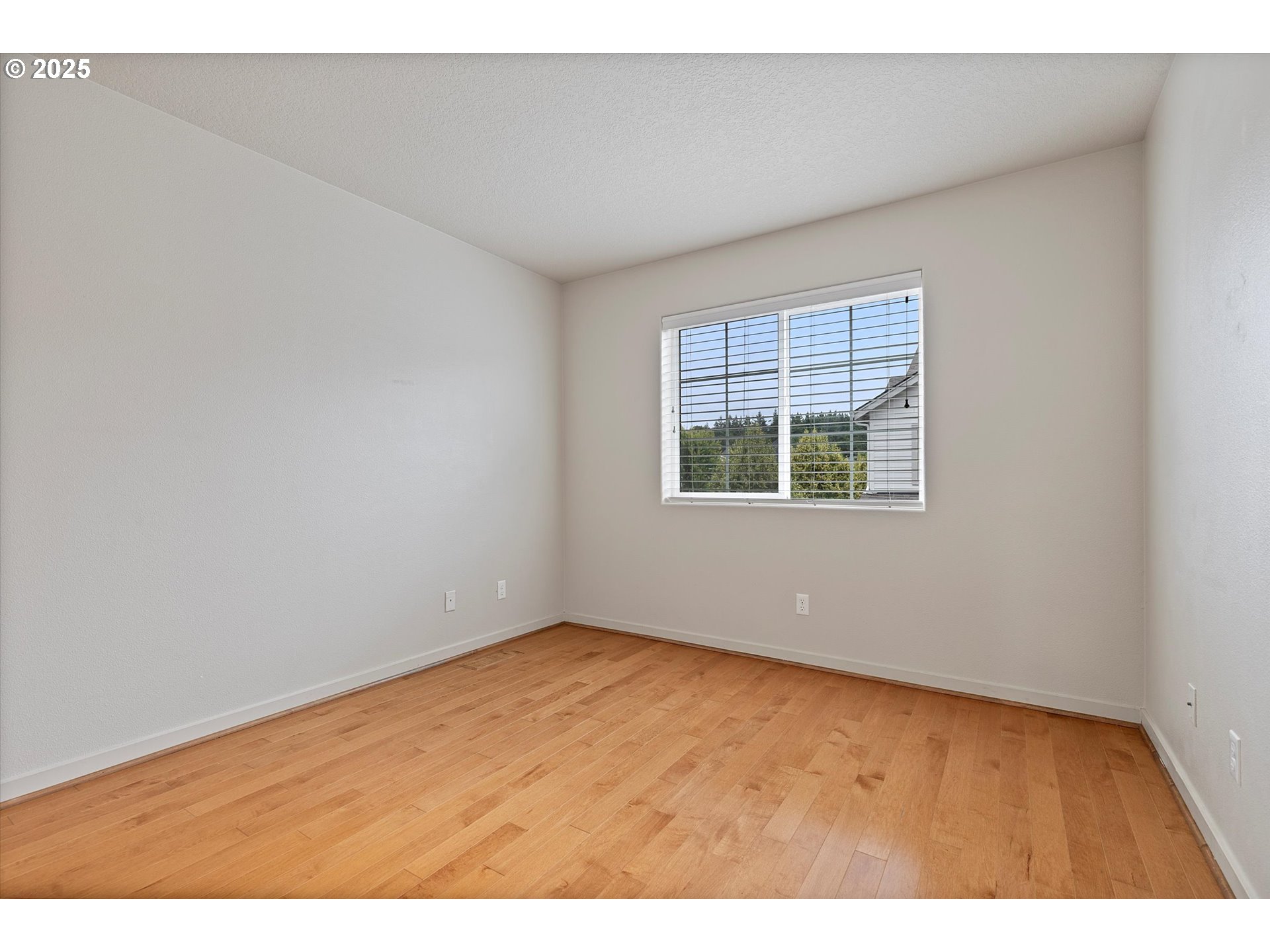 12001 Southwest Surrey Street Wilsonville, OR 97070 - Photo 24 of 48 an empty room with wooden floor and windows
