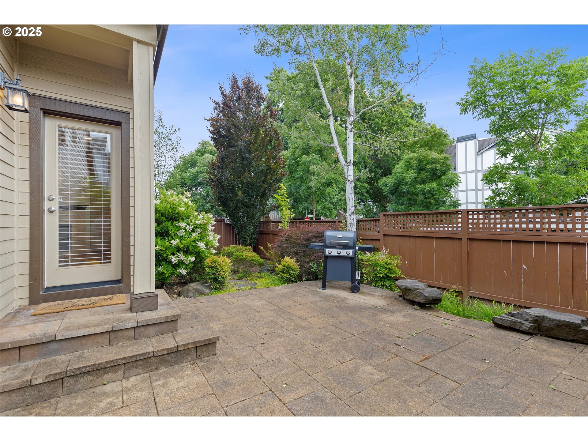 12001 Southwest Surrey Street Wilsonville, OR 97070 - Photo 30 of 48 a backyard of a house with plants and tree