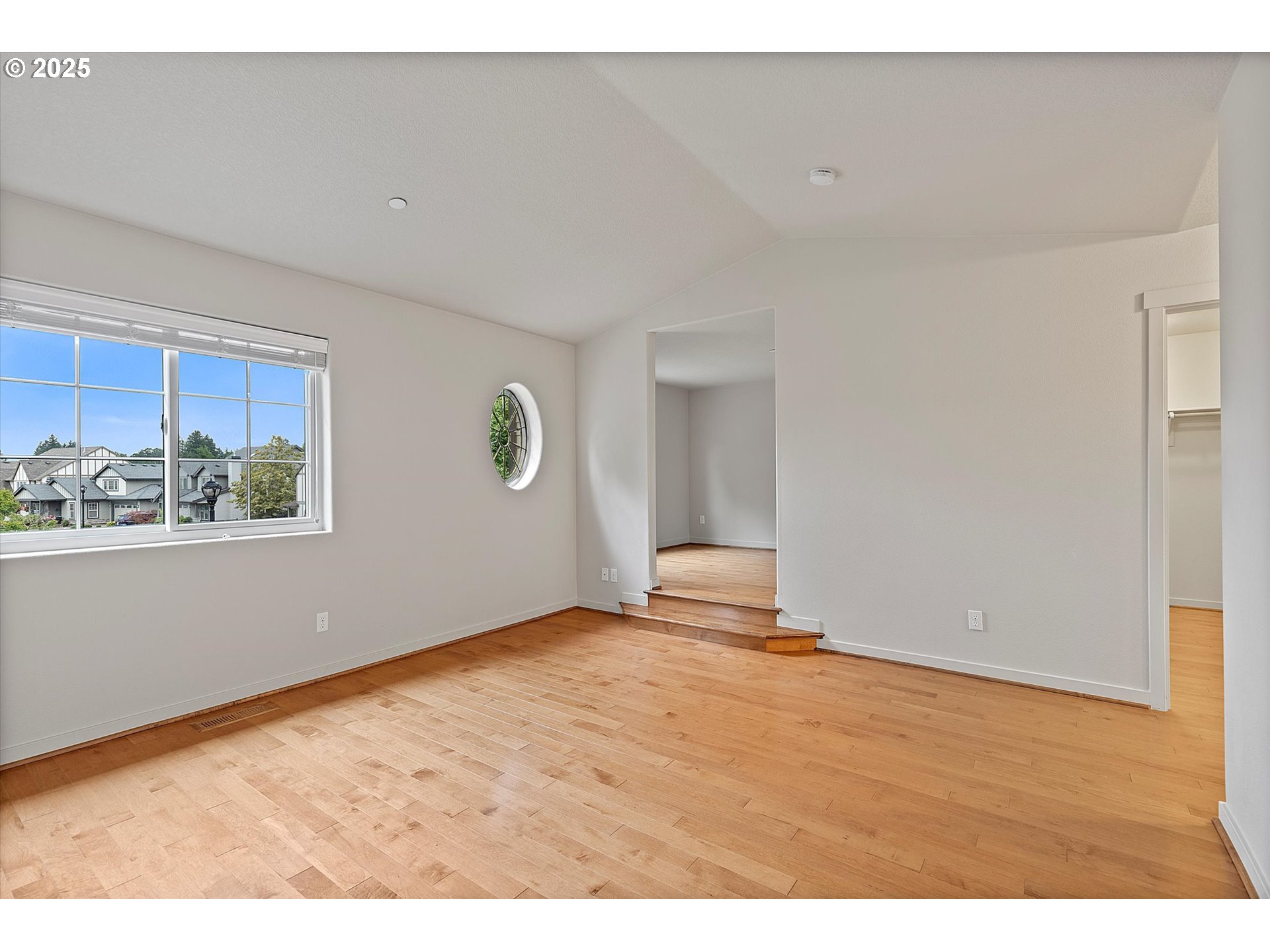 12001 Southwest Surrey Street Wilsonville, OR 97070 - Photo 34 of 48 a view of an empty room with window and wooden floor