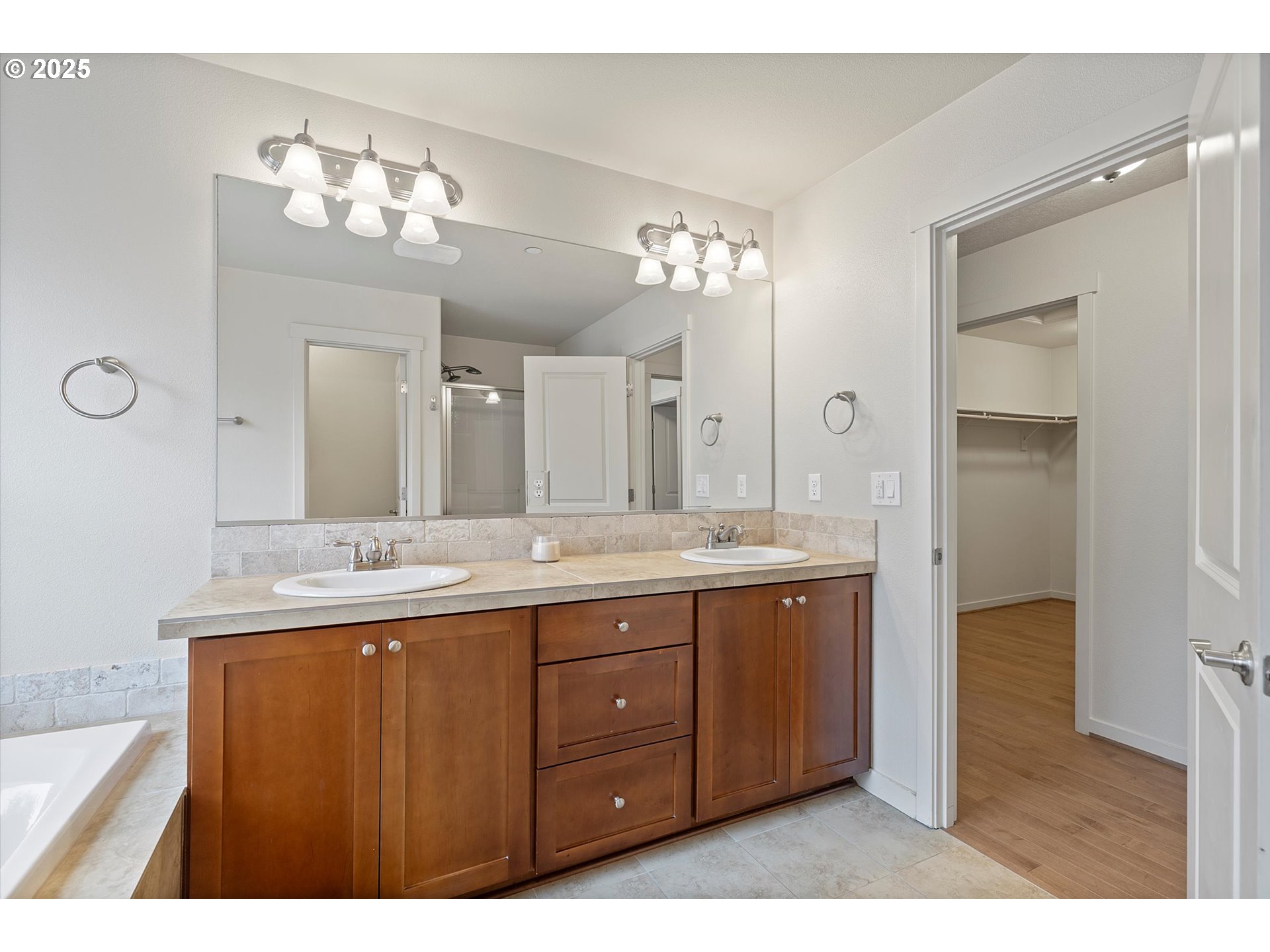 12001 Southwest Surrey Street Wilsonville, OR 97070 - Photo 40 of 48 a bathroom with a granite countertop sink a large mirror and a shower