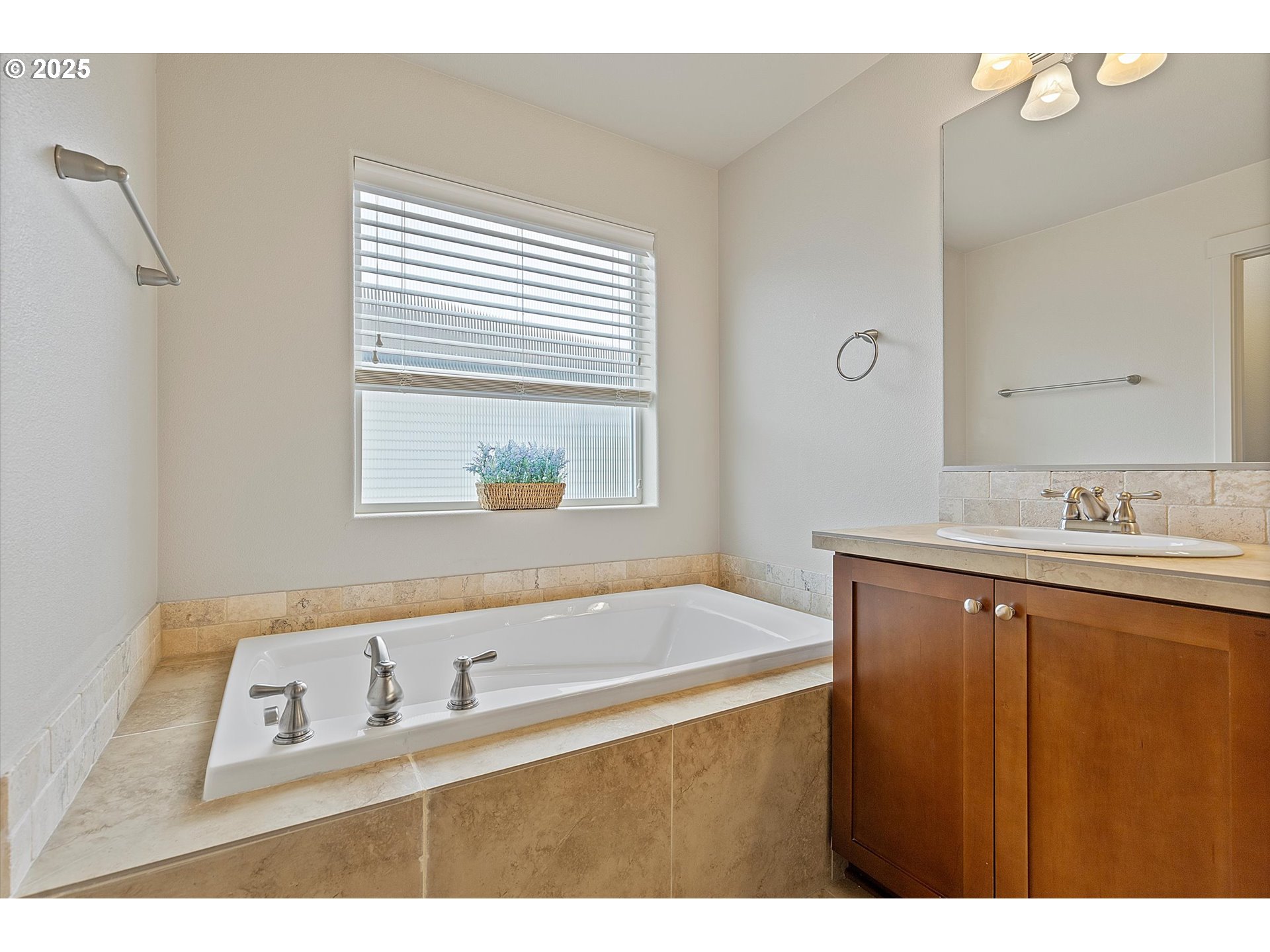 12001 Southwest Surrey Street Wilsonville, OR 97070 - Photo 41 of 48 a bathroom with a sink vanity tub and a mirror