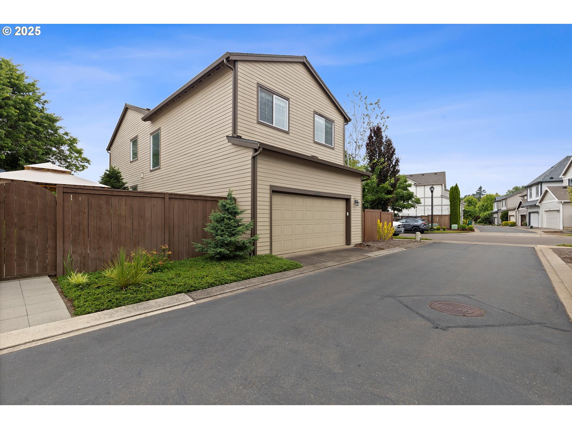 12001 Southwest Surrey Street Wilsonville, OR 97070 - Photo 46 of 48 a front view of a house with a yard and garage