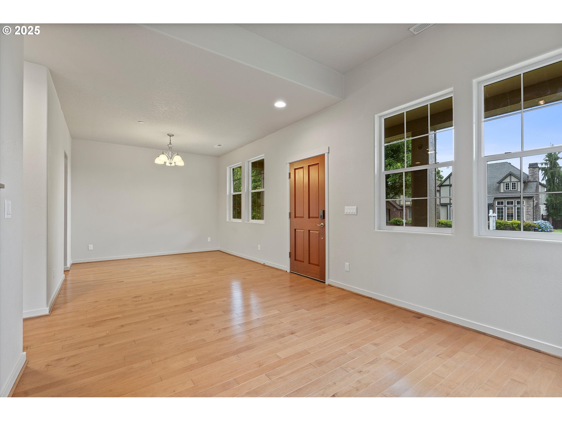 12001 Southwest Surrey Street Wilsonville, OR 97070 - Photo 7 of 48 a view of an empty room with window and wooden floor