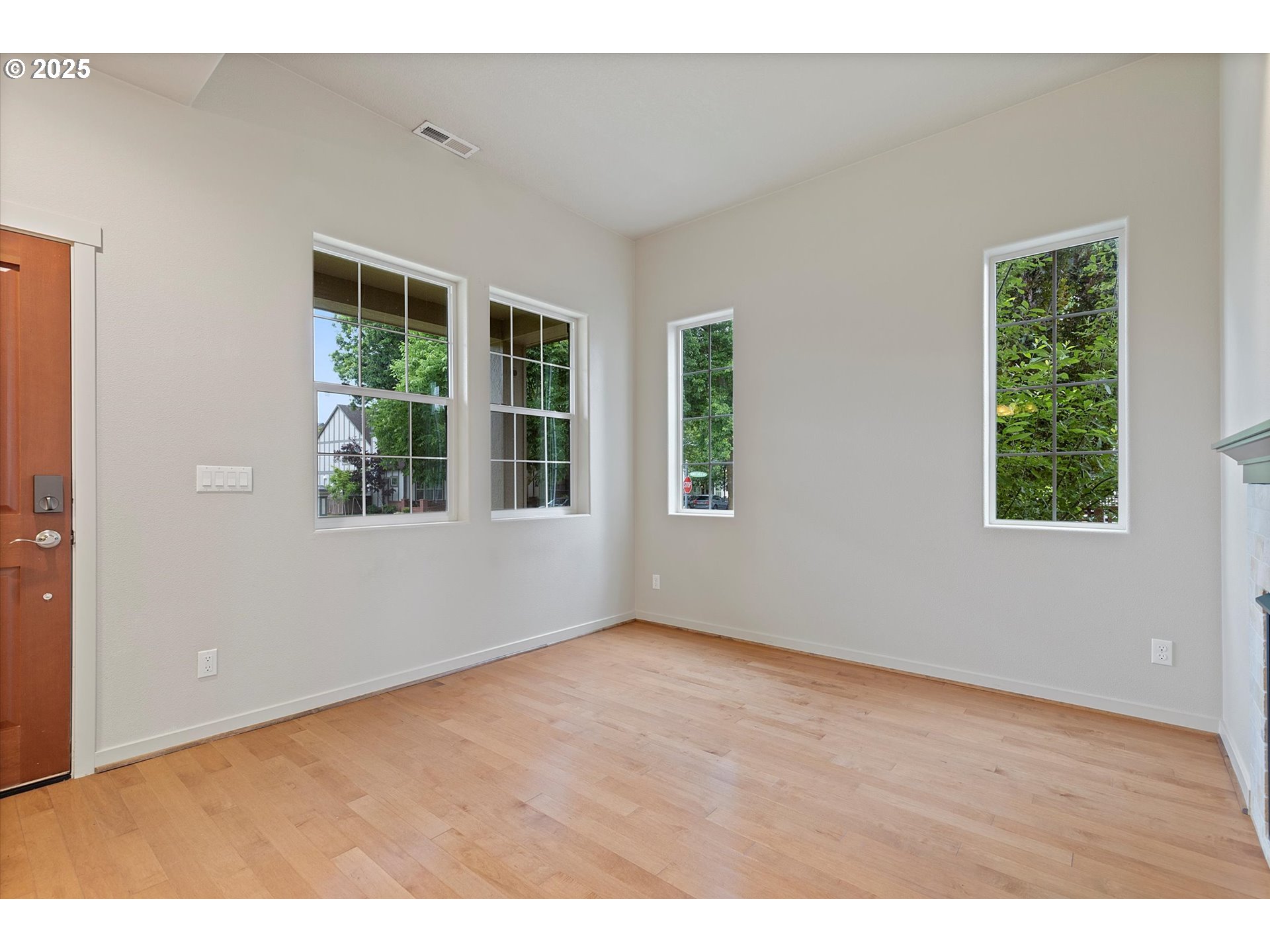 12001 Southwest Surrey Street Wilsonville, OR 97070 - Photo 8 of 48 an empty room with wooden floor and windows