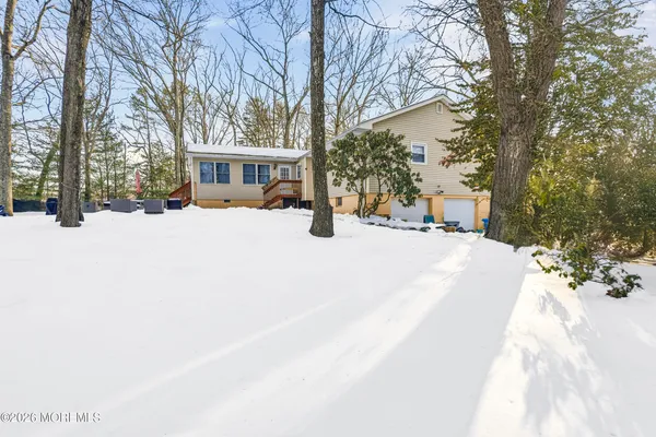 a view of a house with a yard covered in snow