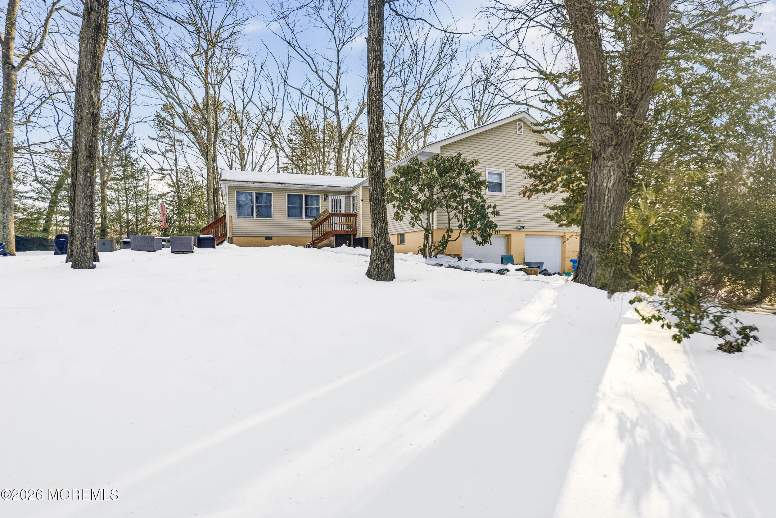 523 Cerrina Road Jackson, NJ 08527 - Photo 2 of 10 a view of a house with a yard covered in snow
