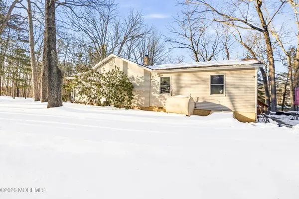 a view of a house with snow on the road