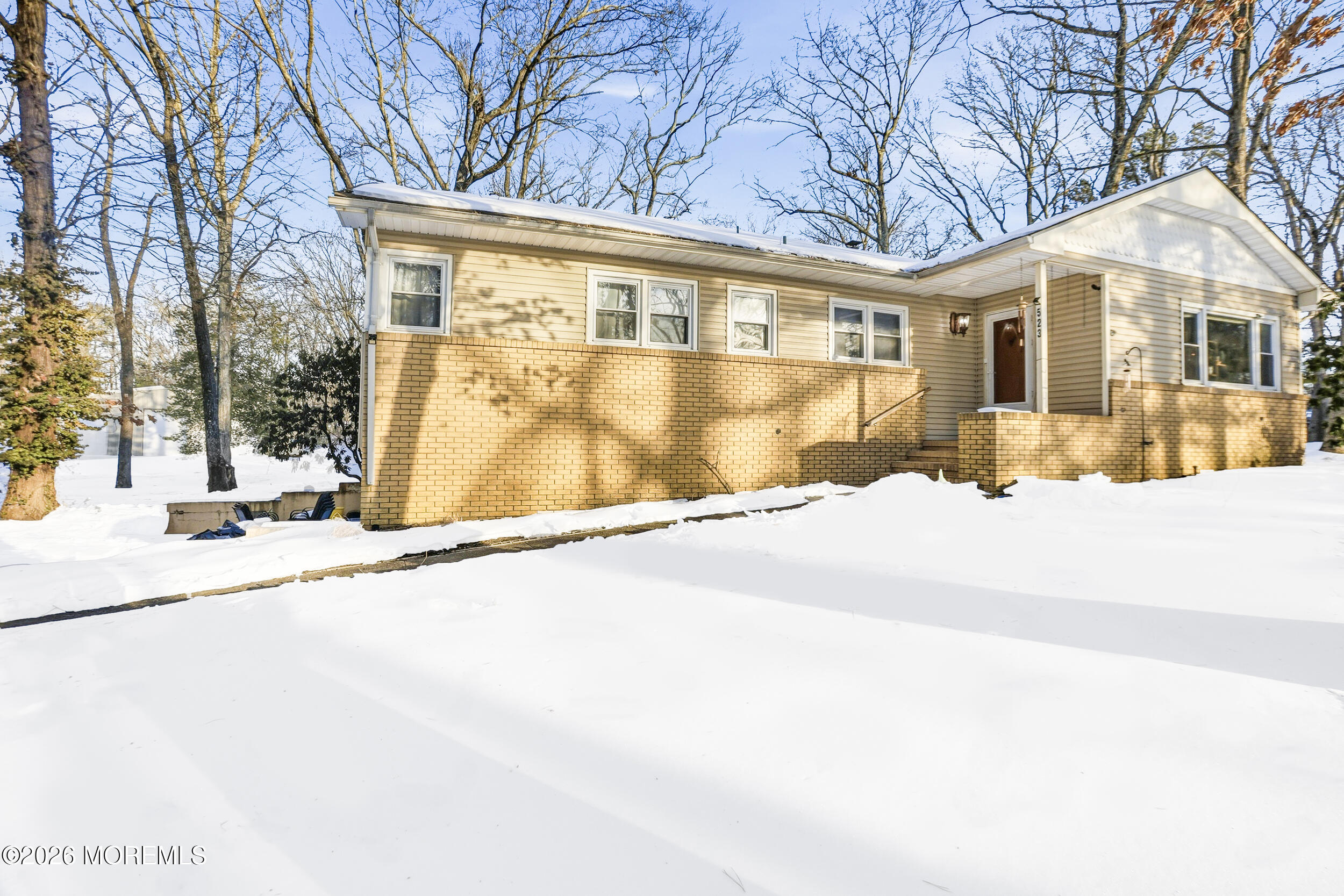 523 Cerrina Road Jackson, NJ 08527 - Photo 8 of 10 a front view of a house with a yard and covered with snow