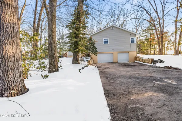 a view of a white house with a yard covered in snow
