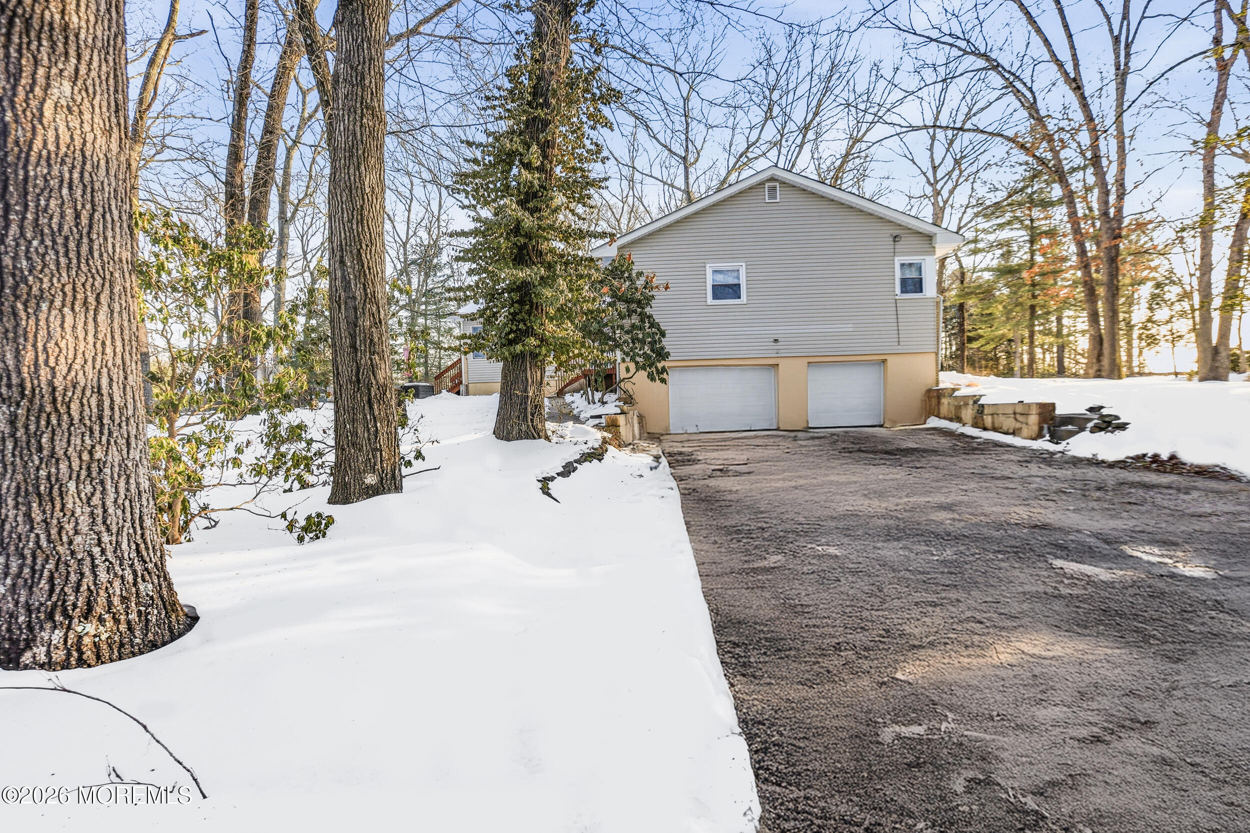 523 Cerrina Road Jackson, NJ 08527 - Photo 9 of 10 a view of a white house with a yard covered in snow