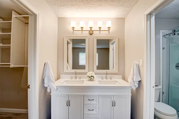 a bathroom with a sink double vanity and a mirror