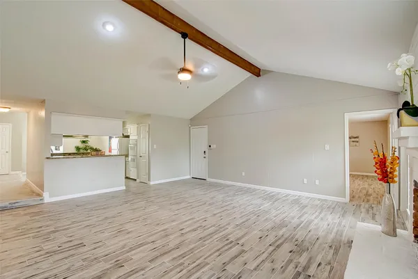 a view of a kitchen with wooden floor and a sink