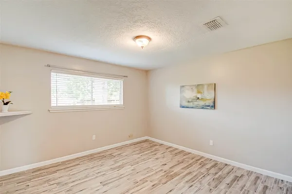 a view of a room with wooden floor and window