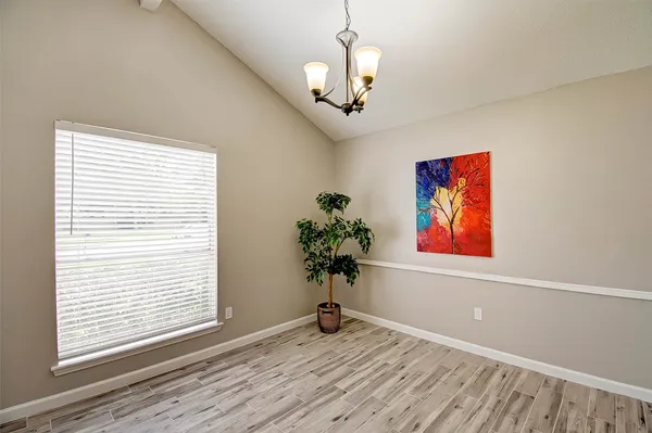 a view of a room with a painting on the wall