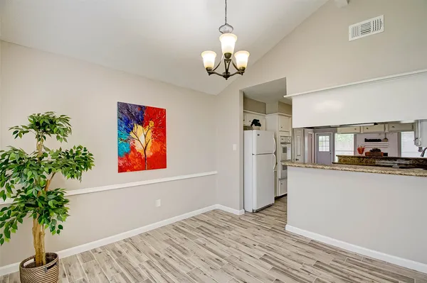 a view of a bedroom with wooden floor and cabinet