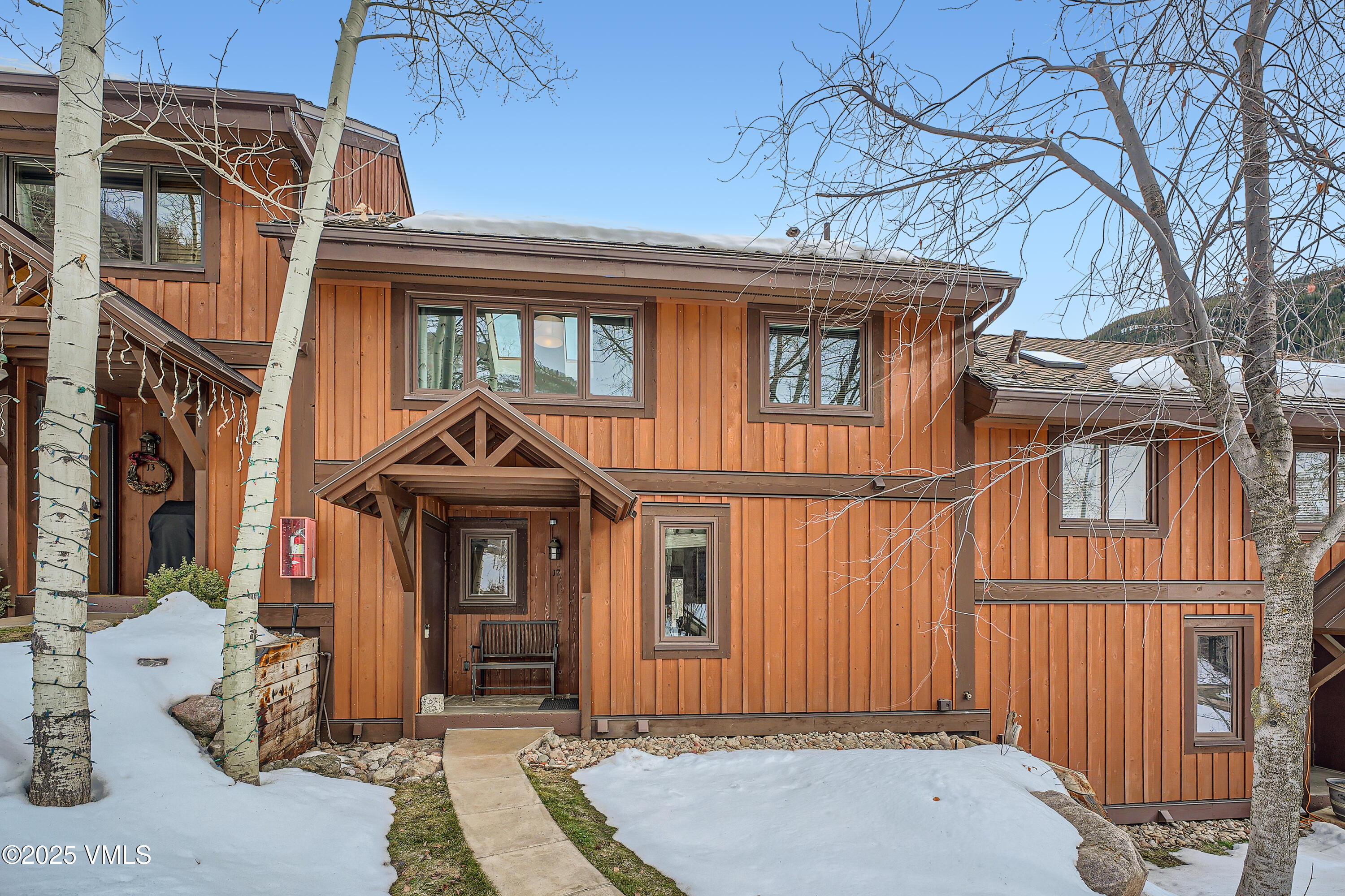 2875 Manns Ranch Road, Unit J2 Vail, CO 81657 - Photo 24 of 25 a front view of a house with a yard
