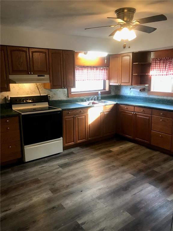 85 Dixon Road Clymer, PA 15728 - Photo 5 of 16 a kitchen with granite countertop a stove a sink and a microwave