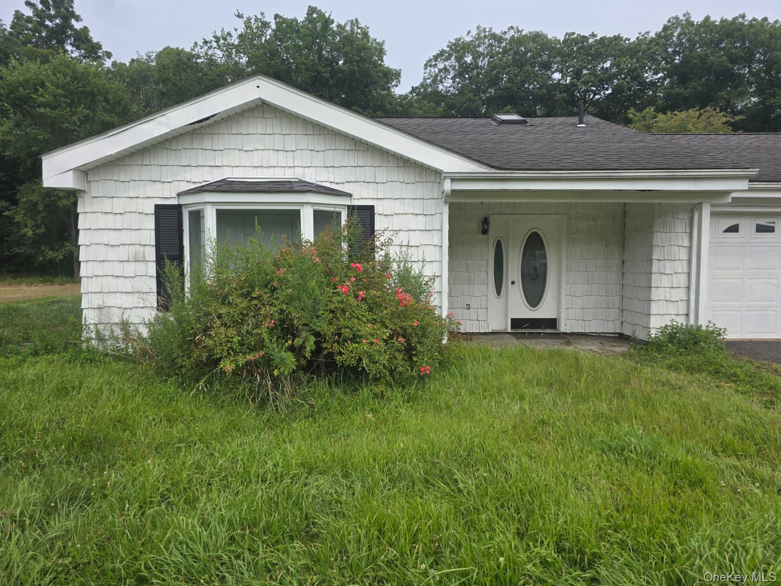 a front view of a house with garden