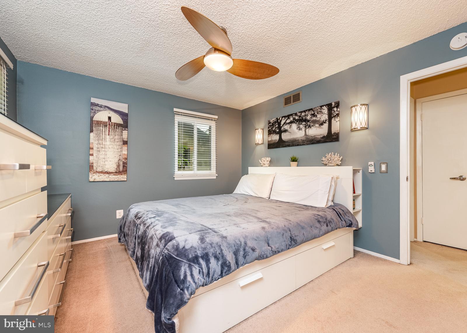 5405 Lightning View Road Columbia, MD 21045 - Photo 18 of 50 Master bedroom with sconce lights and ceiling fan