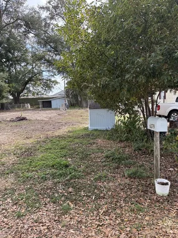 a backyard of a house with lots of green space