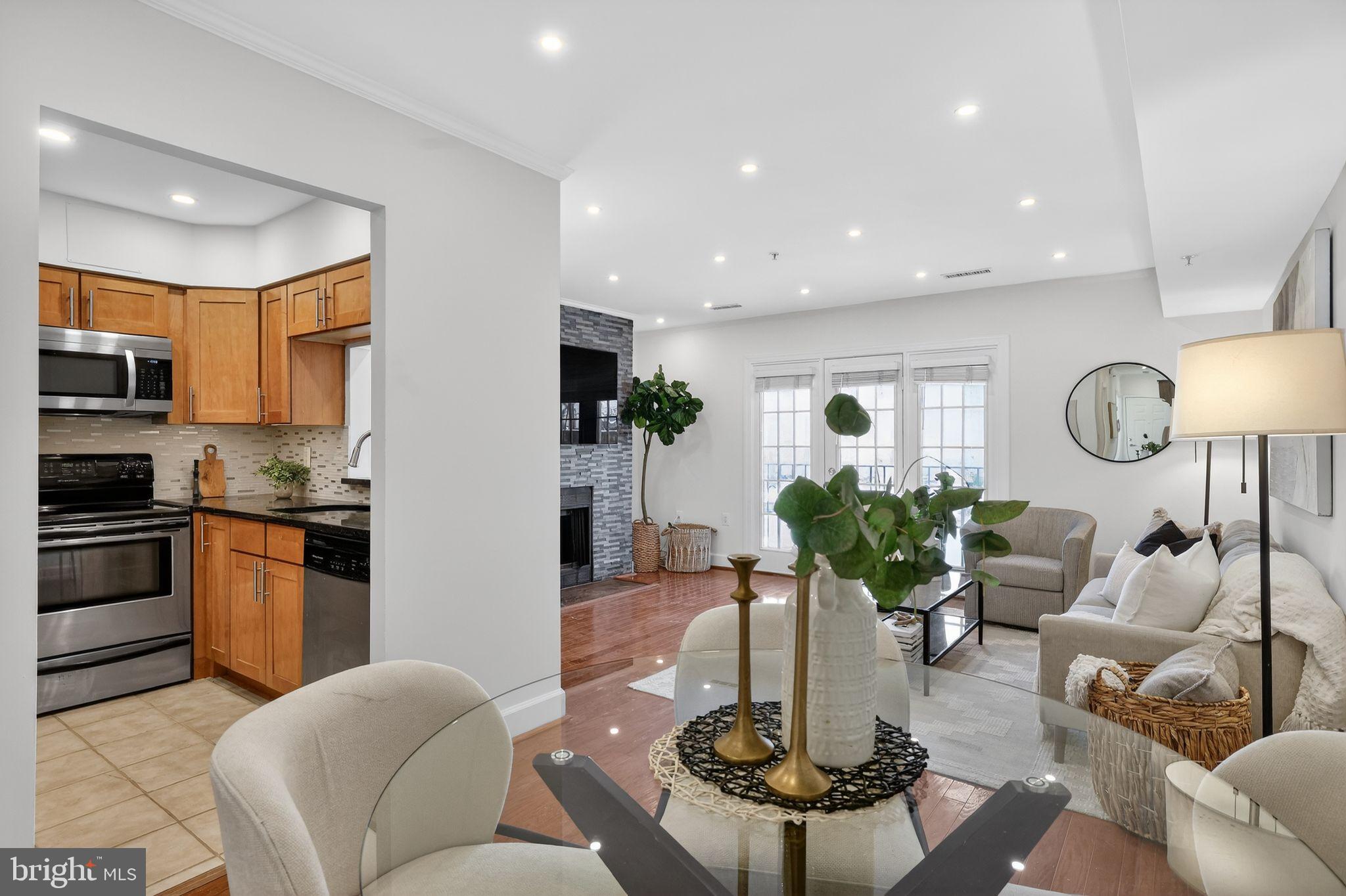 3805 Porter Street Northwest, Unit 201 Washington, DC 20016 - Photo 14 of 19 a living room with kitchen island furniture and a view of kitchen