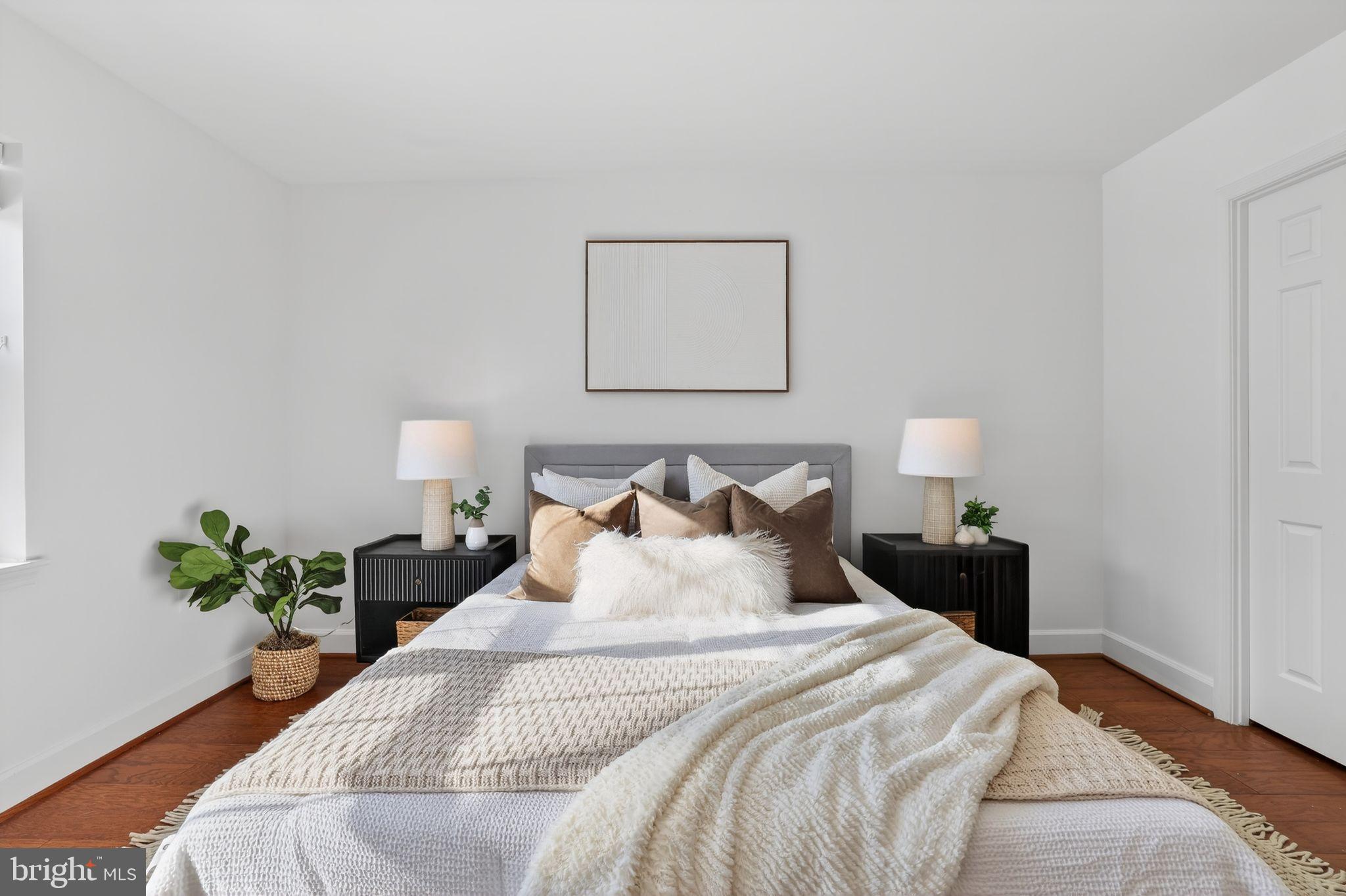 3805 Porter Street Northwest, Unit 201 Washington, DC 20016 - Photo 16 of 19 a bedroom with bed and a potted plant