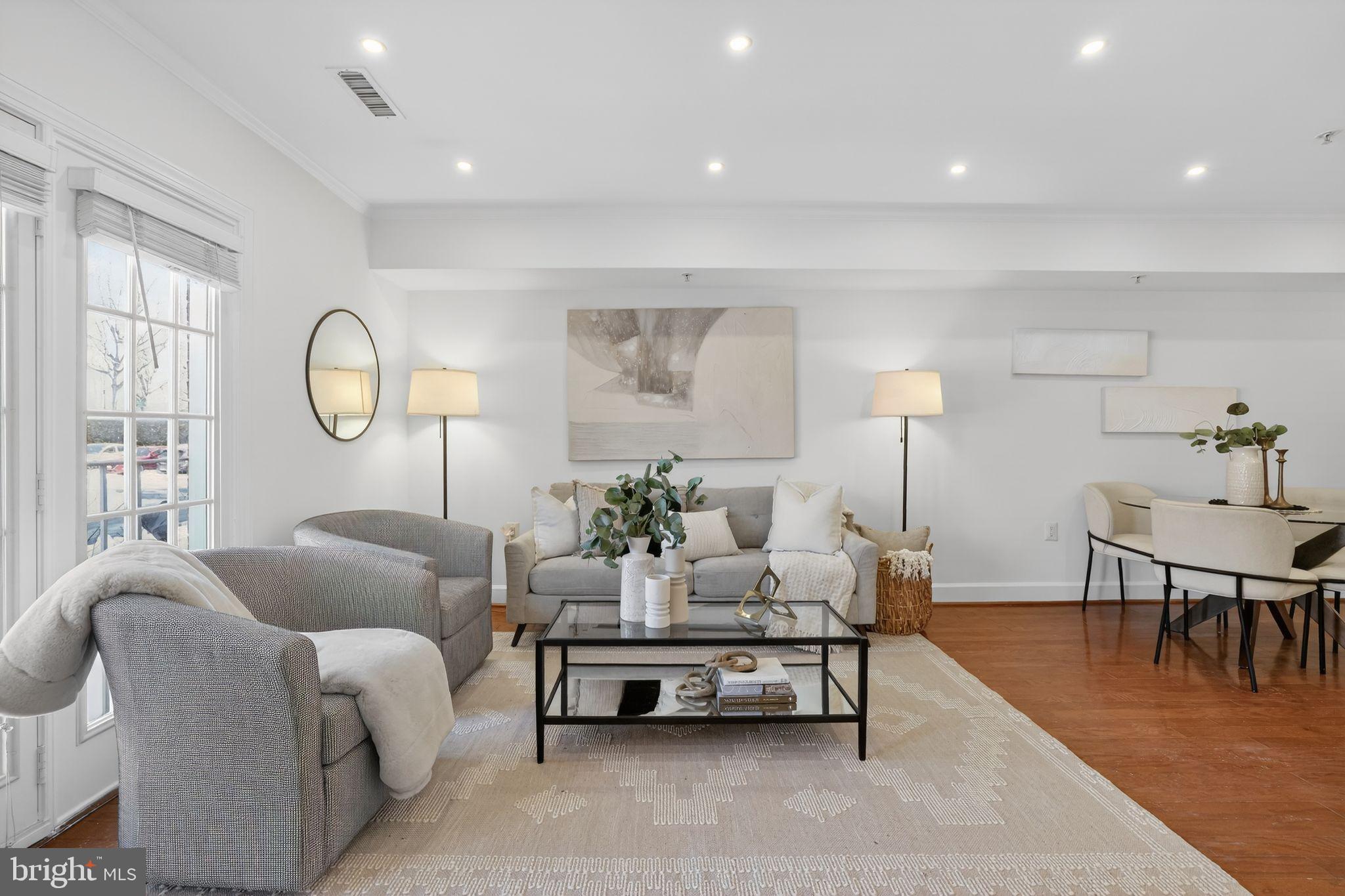 3805 Porter Street Northwest, Unit 201 Washington, DC 20016 - Photo 2 of 19 a living room with furniture a rug potted plant and a large window