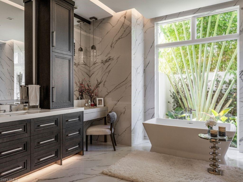 6199 Highcroft Drive Naples, FL 34119 - Photo 17 of 45 Primary bathroom with vanity, and dressing area, a soaking tub, and towel warmer