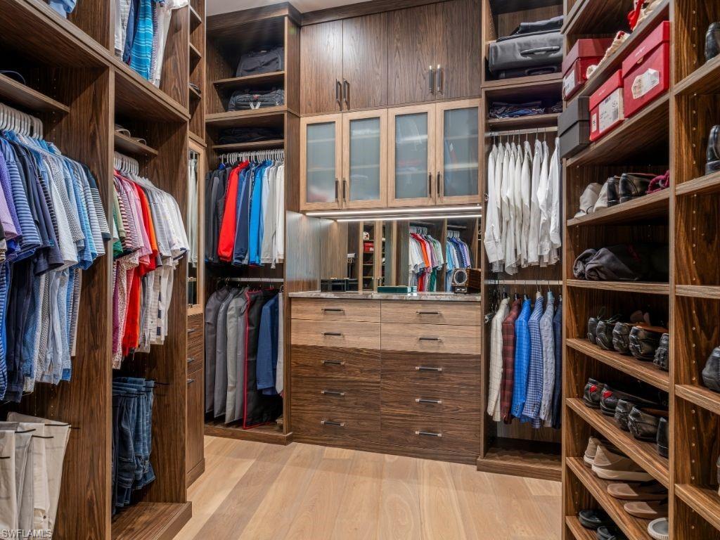 6199 Highcroft Drive Naples, FL 34119 - Photo 21 of 45 Primary walk in closet 2 with light wood-style floors