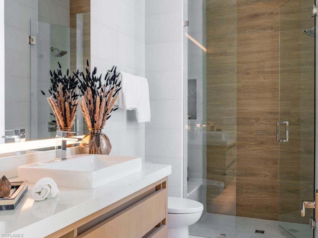 6199 Highcroft Drive Naples, FL 34119 - Photo 27 of 45 Bathroom 3 featuring a shower stall and vanity