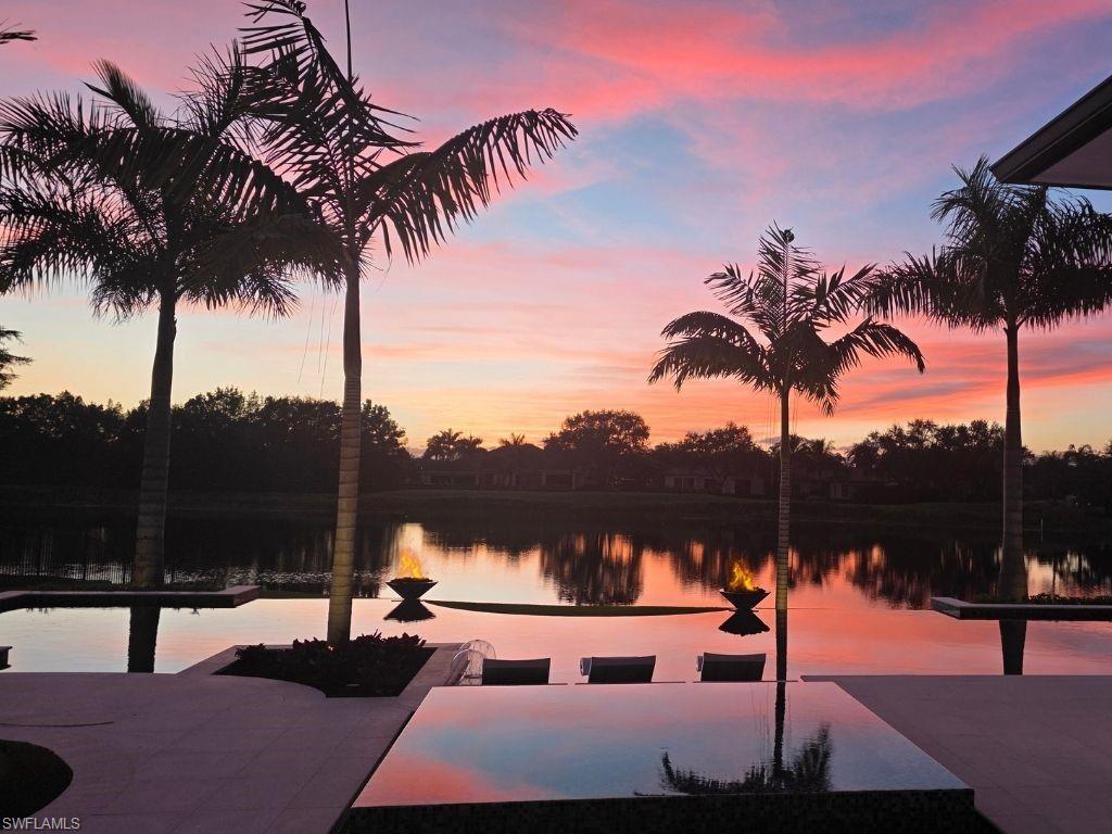6199 Highcroft Drive Naples, FL 34119 - Photo 3 of 45 Infinity edge pool and spa with sunset overlooking the lake