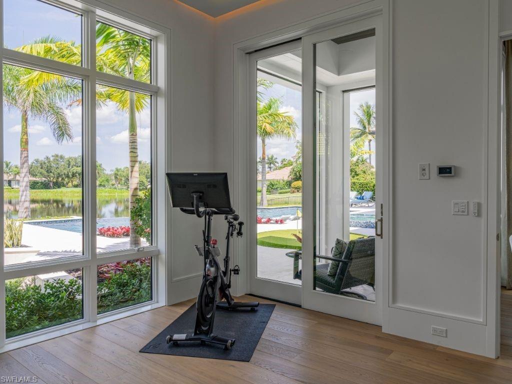 6199 Highcroft Drive Naples, FL 34119 - Photo 31 of 45 Workout area featuring picture window and access to pool