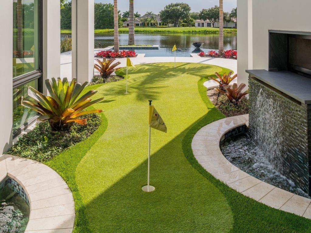 6199 Highcroft Drive Naples, FL 34119 - Photo 42 of 45 Putting green with 2 water features with views of the pool and lake