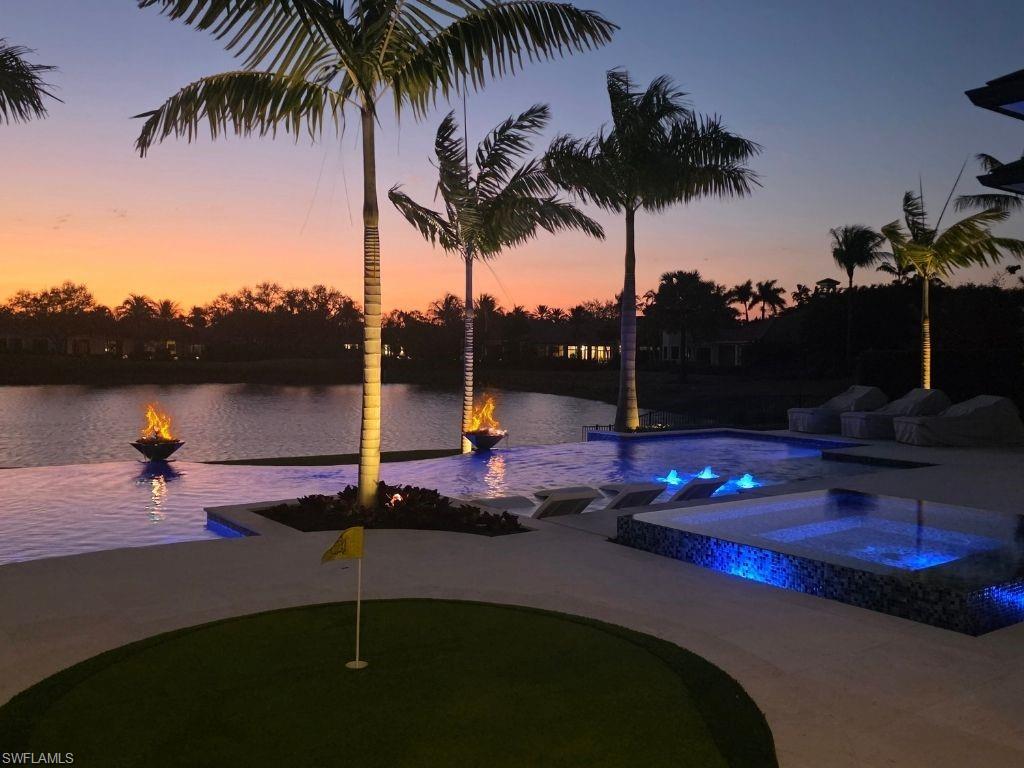 6199 Highcroft Drive Naples, FL 34119 - Photo 45 of 45 Pool at dusk with a putting green and a pool with connected hot tub