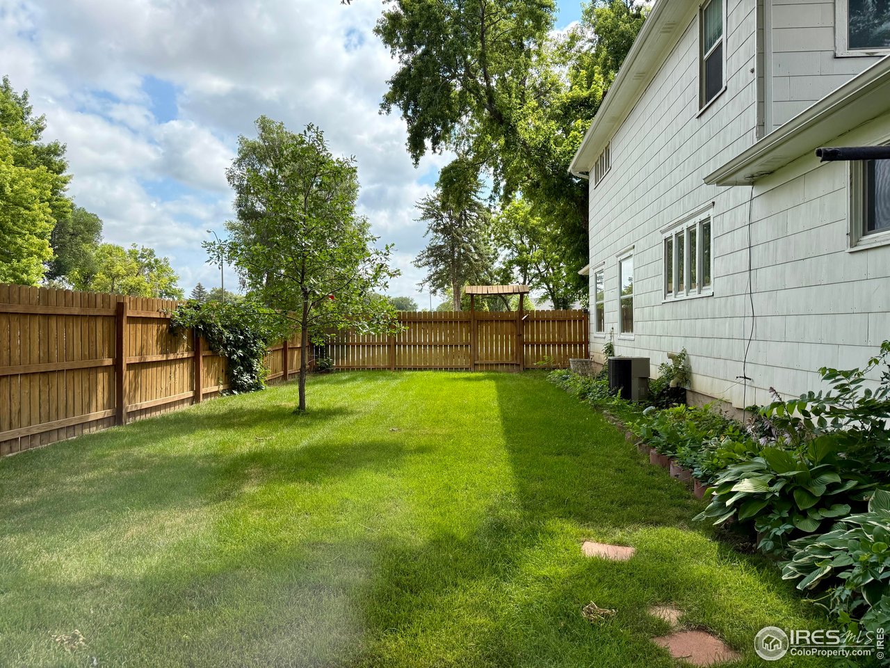 406 South Morlan Avenue Holyoke, CO 80734 - Photo 26 of 38 a view of a backyard with large trees
