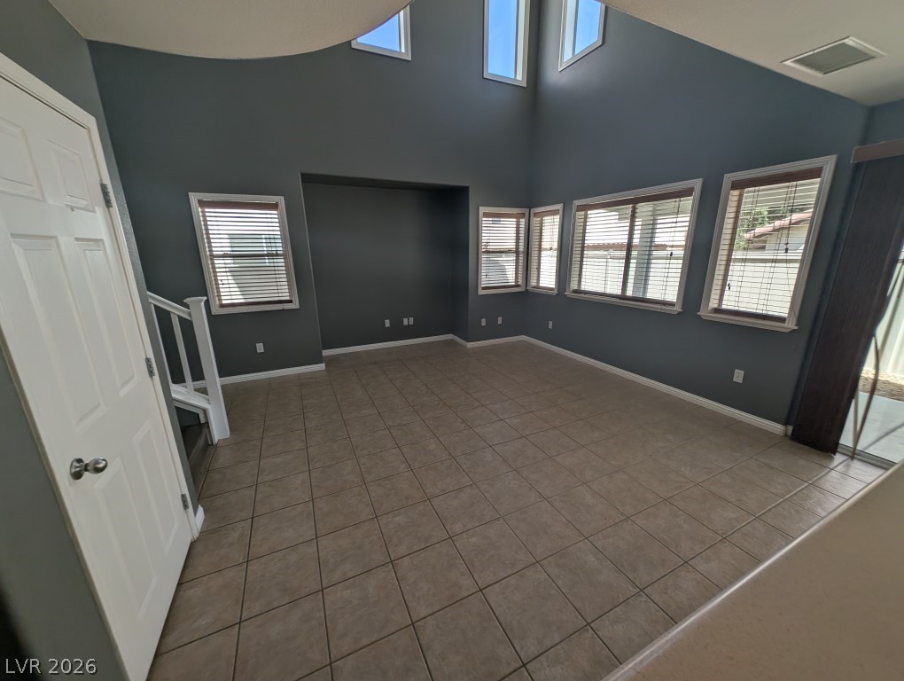 9121 Spoonbill Ridge Place Las Vegas, NV 89143 - Photo 4 of 26 A spacious living area with high ceilings and abundant natural light from numerous windows.